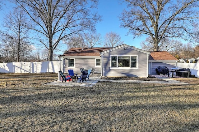 rear view of property with a yard, fence, and a patio