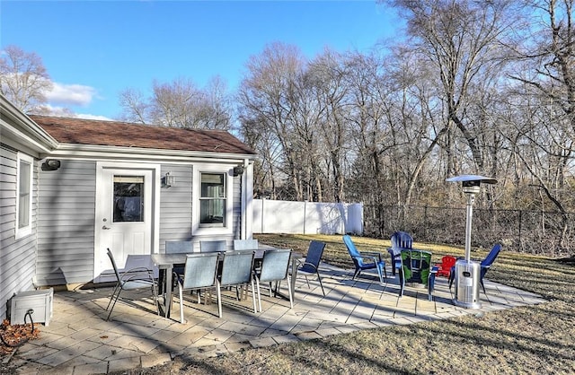 view of patio with fence and outdoor dining space