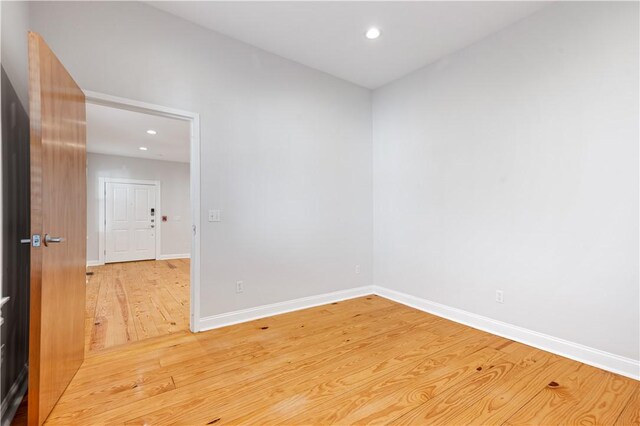 spare room with light wood-style floors, baseboards, and recessed lighting