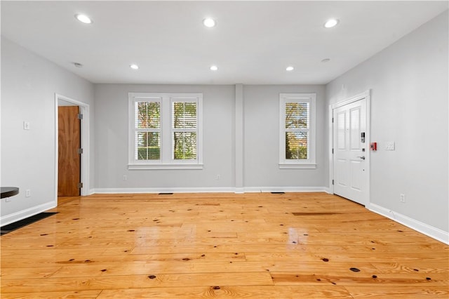 foyer entrance with a healthy amount of sunlight, light wood finished floors, and recessed lighting