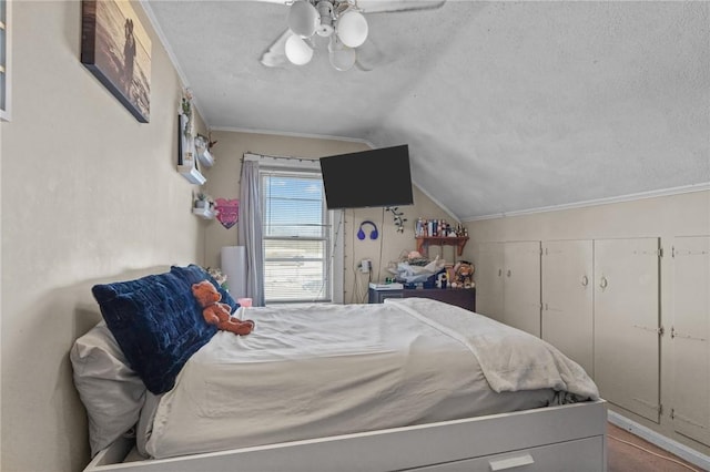 bedroom featuring lofted ceiling, crown molding, a ceiling fan, and a textured ceiling