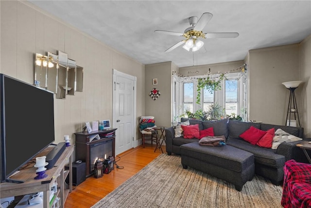 living room with wood finished floors and a ceiling fan