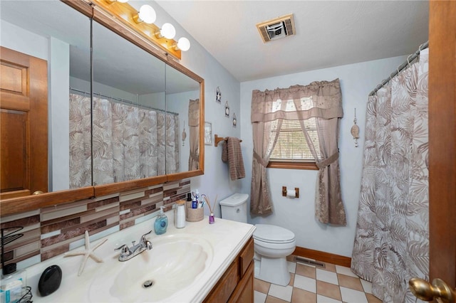 full bath featuring toilet, vanity, visible vents, and tile patterned floors