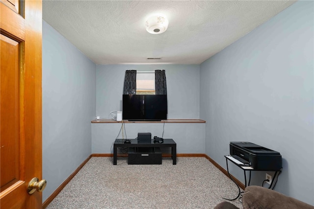 office featuring a textured ceiling, carpet, visible vents, and baseboards