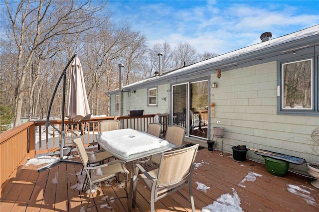 wooden terrace featuring outdoor dining area