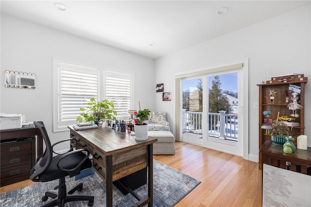 office space featuring baseboards, light wood-style flooring, and recessed lighting