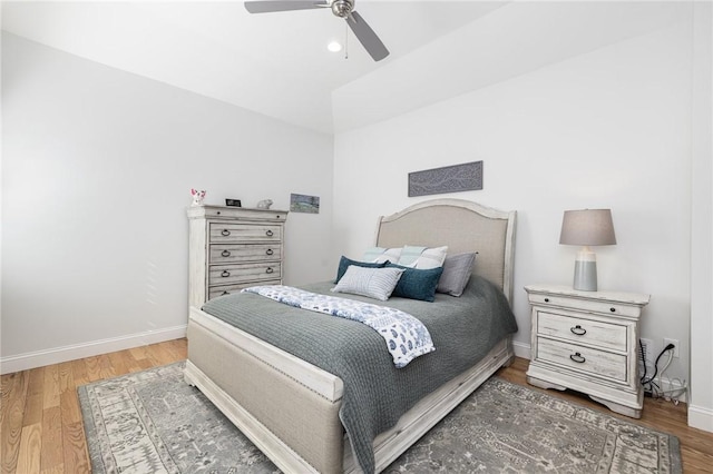 bedroom featuring ceiling fan, baseboards, and wood finished floors