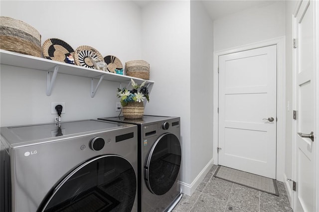 laundry area featuring laundry area, independent washer and dryer, granite finish floor, and baseboards