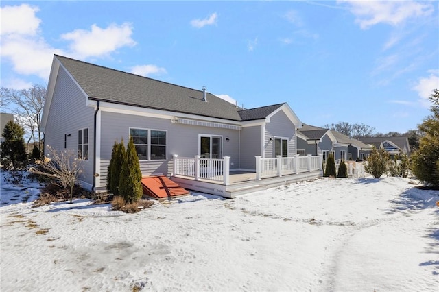 snow covered property featuring a deck