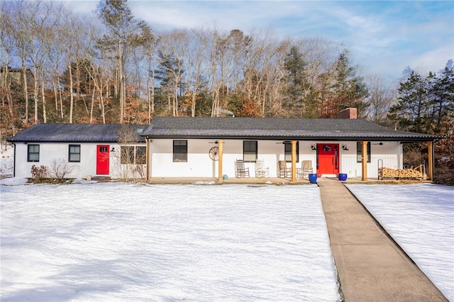 view of front of property with covered porch and a chimney