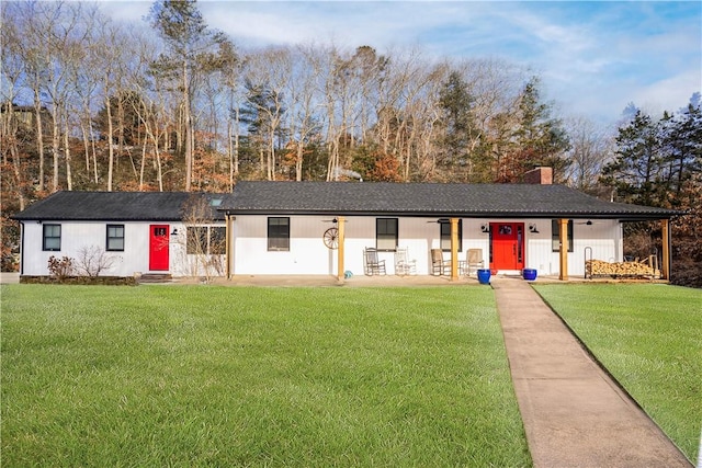 view of front of home with a front lawn and a chimney