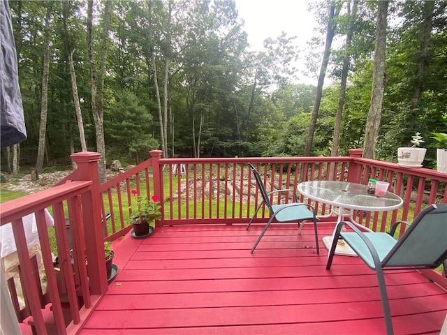 wooden terrace with outdoor dining area