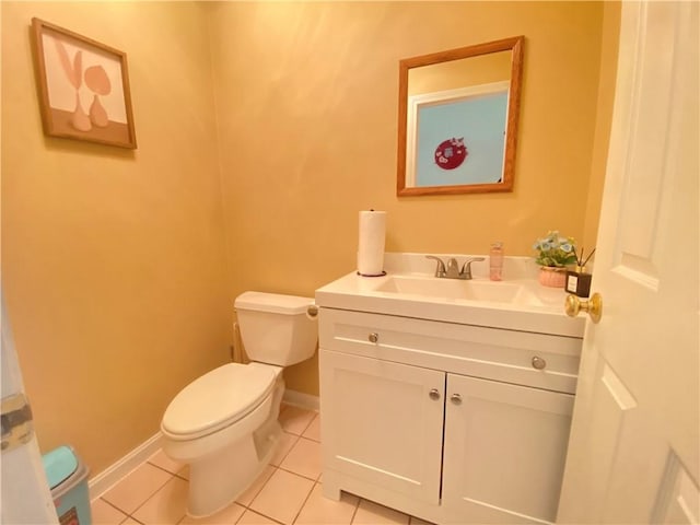 half bath with vanity, tile patterned flooring, toilet, and baseboards