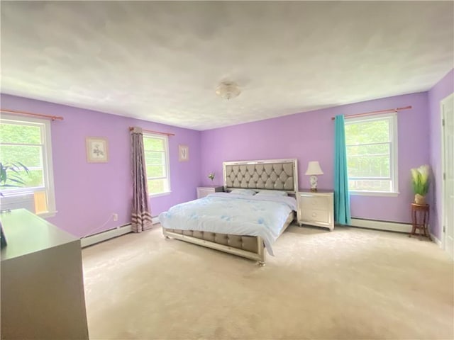 bedroom featuring a baseboard heating unit, a baseboard radiator, multiple windows, and light colored carpet