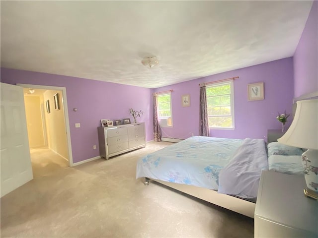 bedroom with baseboards, light colored carpet, and baseboard heating