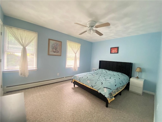 carpeted bedroom with ceiling fan, baseboard heating, and baseboards