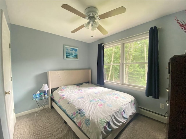 carpeted bedroom with ceiling fan, a baseboard radiator, and baseboards