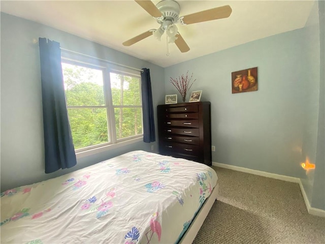 carpeted bedroom featuring a ceiling fan and baseboards