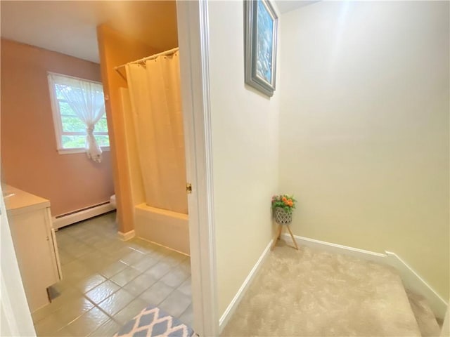 full bathroom with shower / bath combo, baseboards, baseboard heating, and vanity