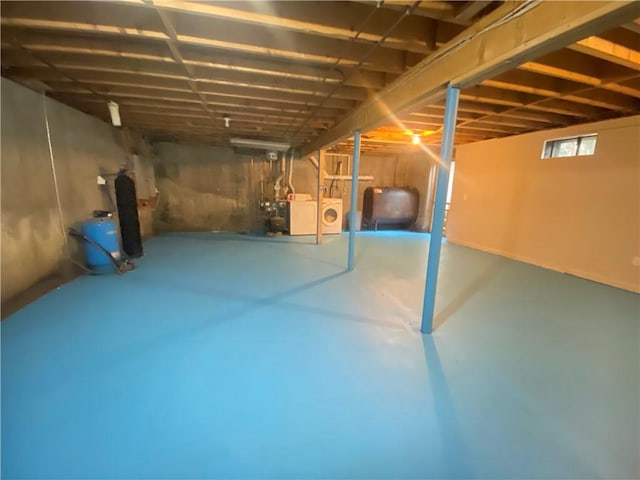 basement featuring independent washer and dryer and heating fuel