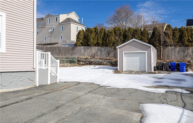 detached garage featuring fence