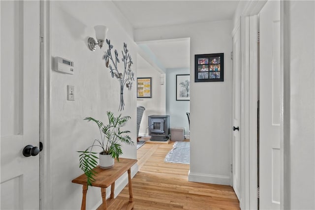 corridor with wood finished floors and baseboards