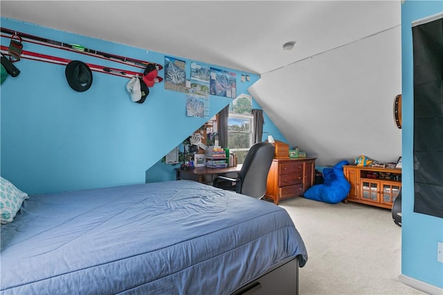 bedroom featuring light colored carpet and vaulted ceiling