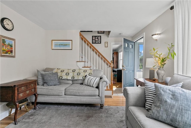 living room featuring stairway and wood finished floors