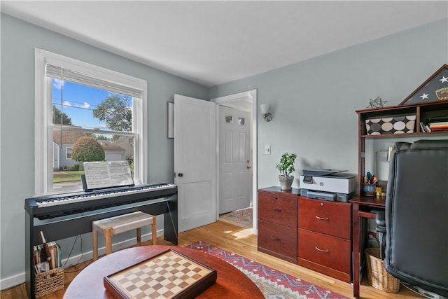 office area with light wood-type flooring and baseboards