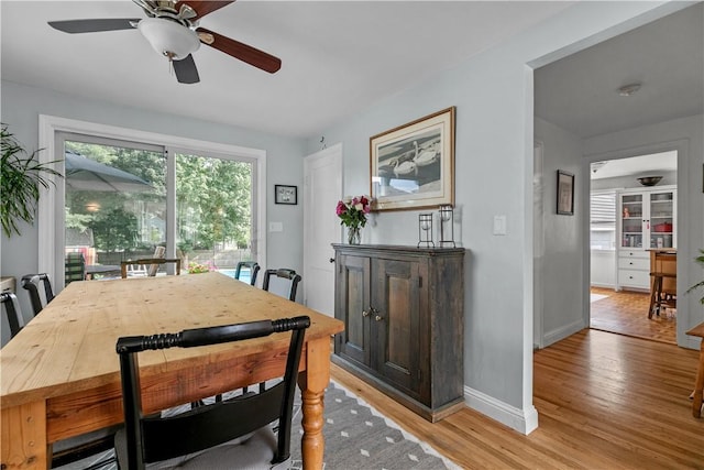 dining space featuring light wood finished floors and baseboards