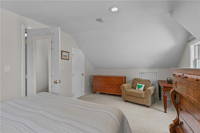 bedroom featuring light carpet and lofted ceiling