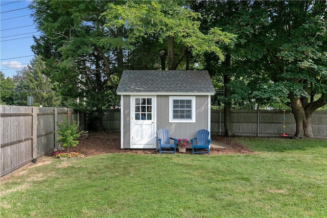 view of shed with a fenced backyard