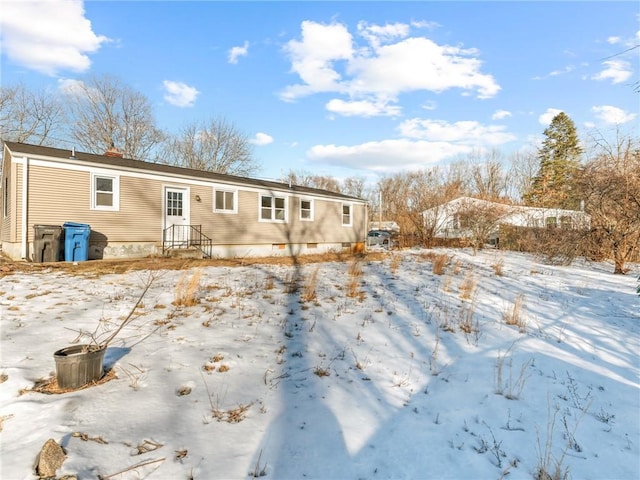 snow covered property with crawl space