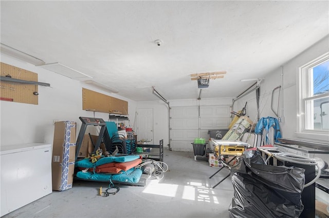 garage featuring refrigerator and a garage door opener