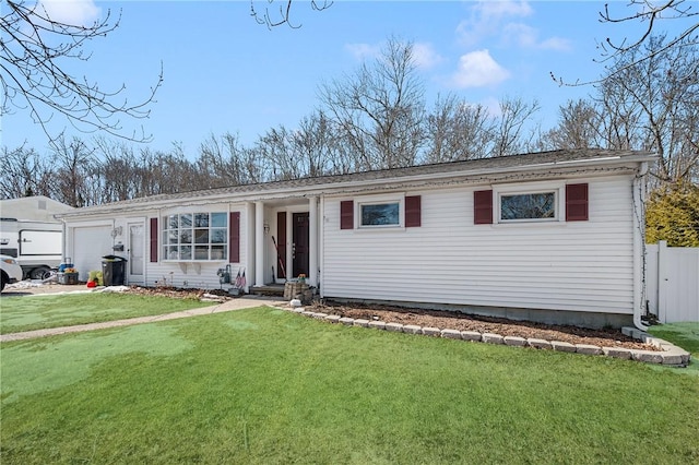 ranch-style house with a garage and a front lawn