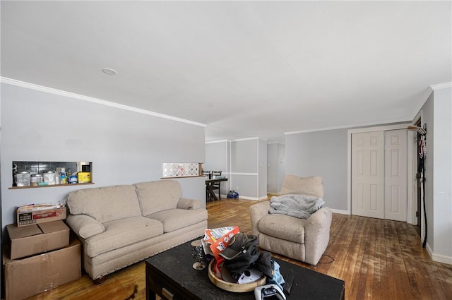 living room featuring crown molding, baseboards, and wood finished floors