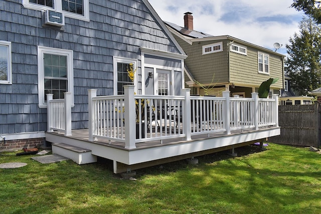 wooden terrace with a lawn and fence