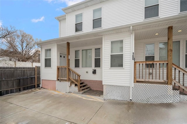 rear view of house featuring a patio area and fence