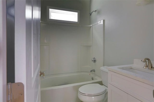 bathroom featuring washtub / shower combination, vanity, and toilet