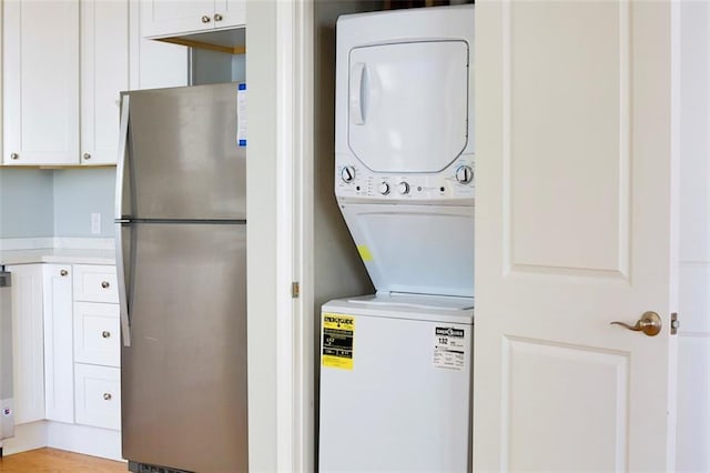 clothes washing area with laundry area and stacked washer / dryer