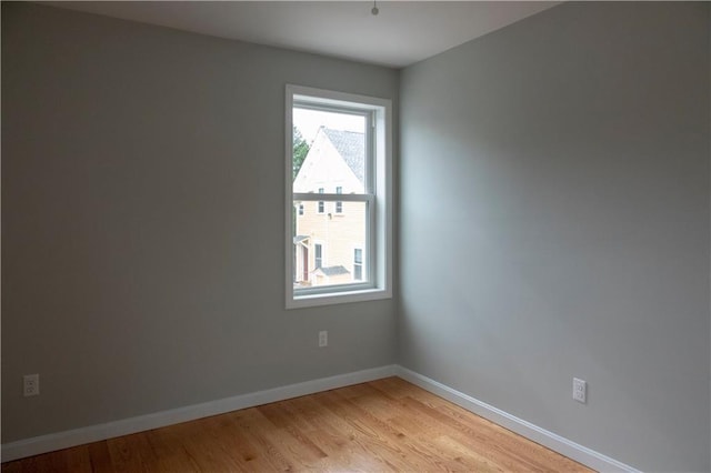 unfurnished room featuring light wood-style floors and baseboards