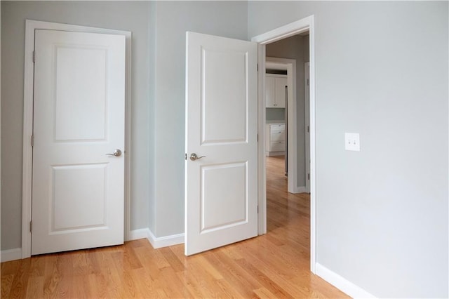 unfurnished bedroom with light wood-style floors and baseboards