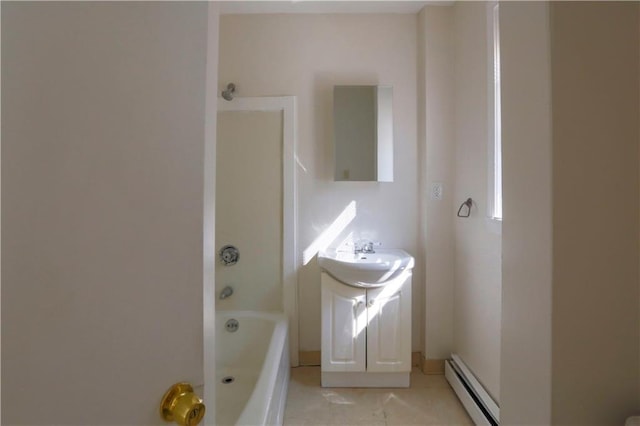 bathroom with a baseboard radiator, tile patterned flooring, a sink, and a bathing tub