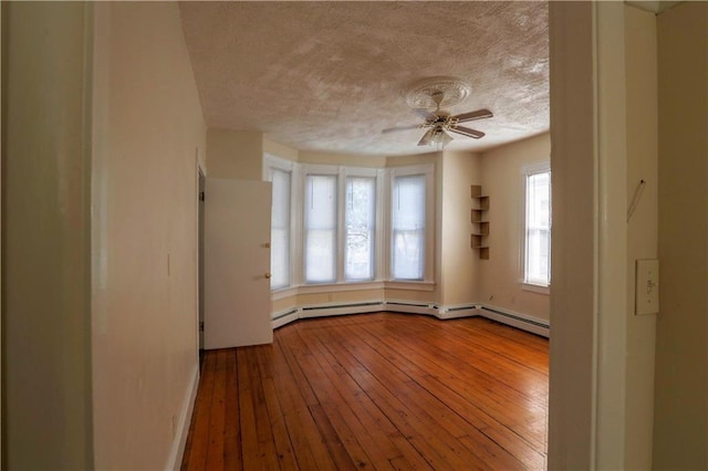 unfurnished room featuring a ceiling fan, a textured ceiling, and wood finished floors