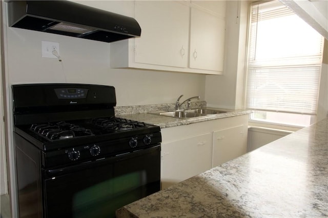 kitchen with a sink, white cabinetry, ventilation hood, light stone countertops, and gas stove