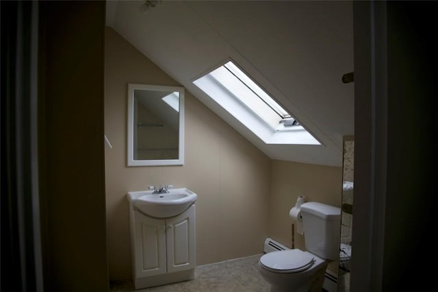 bathroom with toilet, lofted ceiling with skylight, a baseboard heating unit, and vanity