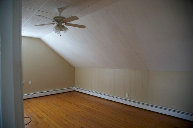 bonus room featuring lofted ceiling, a baseboard radiator, a ceiling fan, and wood finished floors