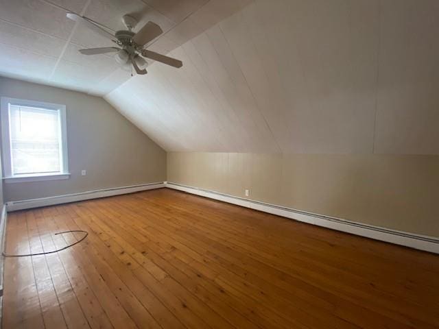 additional living space with ceiling fan, vaulted ceiling, and wood finished floors