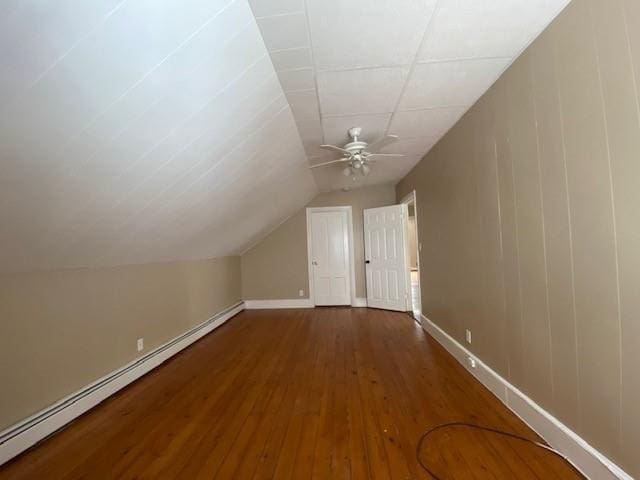 bonus room with a baseboard radiator, wood finished floors, a ceiling fan, and baseboards