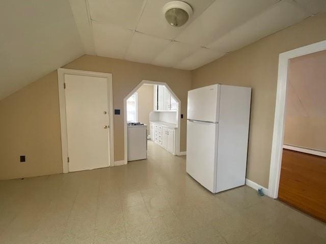 additional living space featuring lofted ceiling and light floors